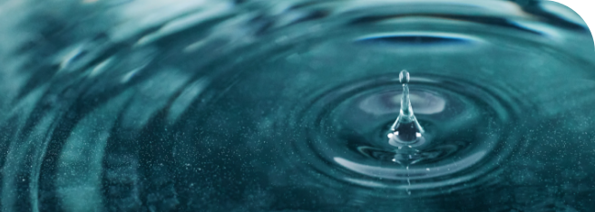 Water droplet creating ripples on a smooth surface, symbolizing advanced filtration systems as part of core water purification technologies