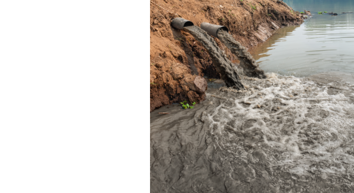 Polluted wastewater flowing from drainage pipes into a river, illustrating environmental damage and infrastructure challenges in the global water crisis