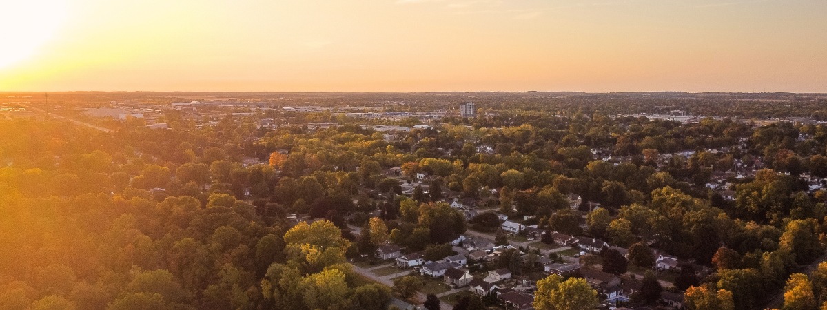 Aerial view of a rural Ontario community at sunset, representing housing expansion supported by Miranda Water Technologies’ Miracell® wastewater treatment system.