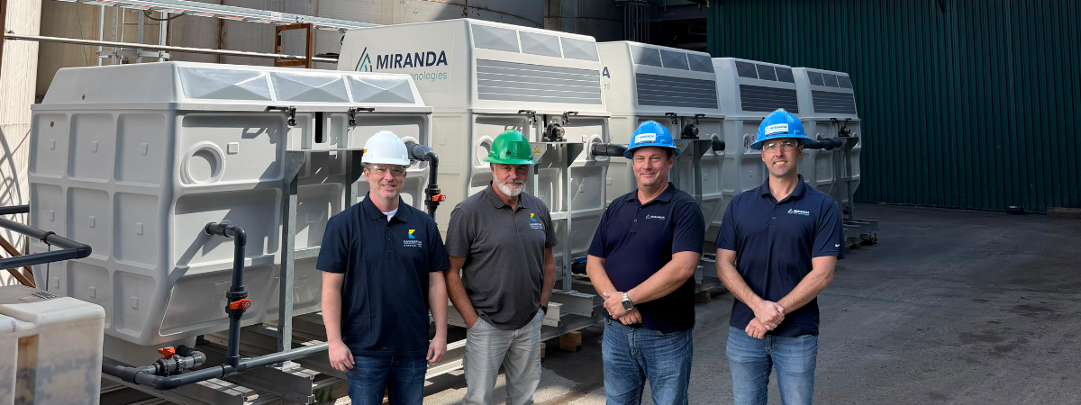 Jeff Menzies and Bill Harris of Kawartha Ethanol with Michael Skinner and Jamie Mason of Miranda Water Technologies, standing in front of industrial wastewater treatment equipment at Kawartha Ethanol’s facility in Havelock, Ontario.